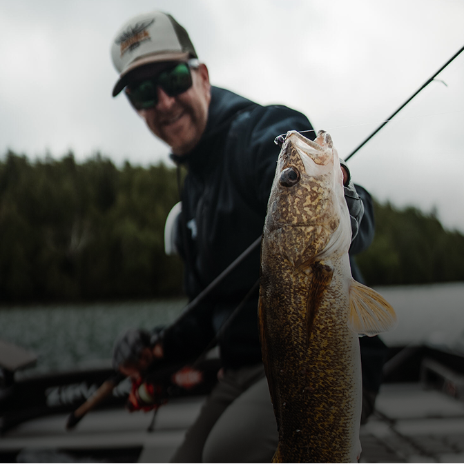 man fishing walleye using fenwick rod