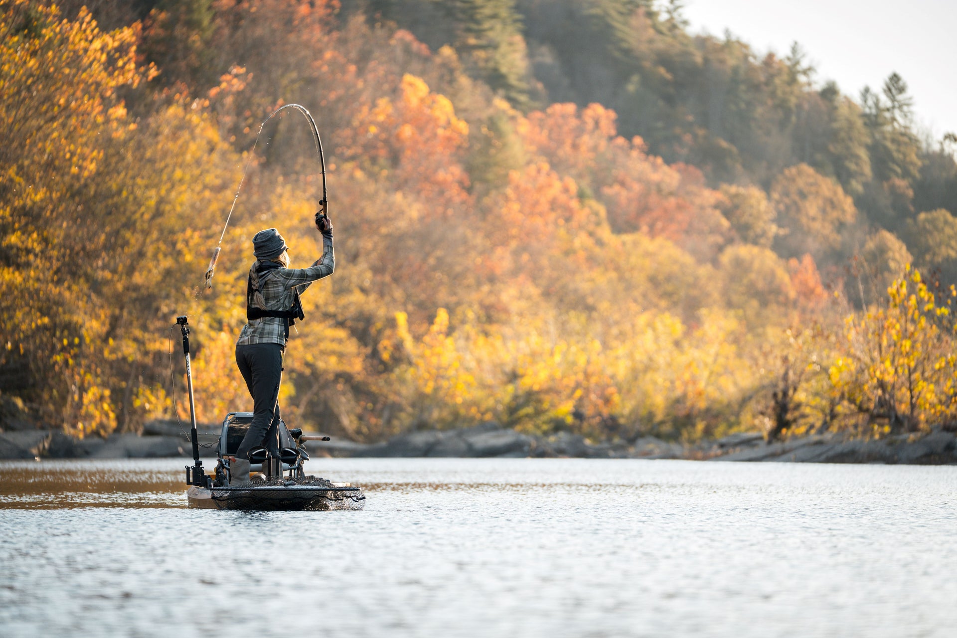 Woman fishing alone on a lake 