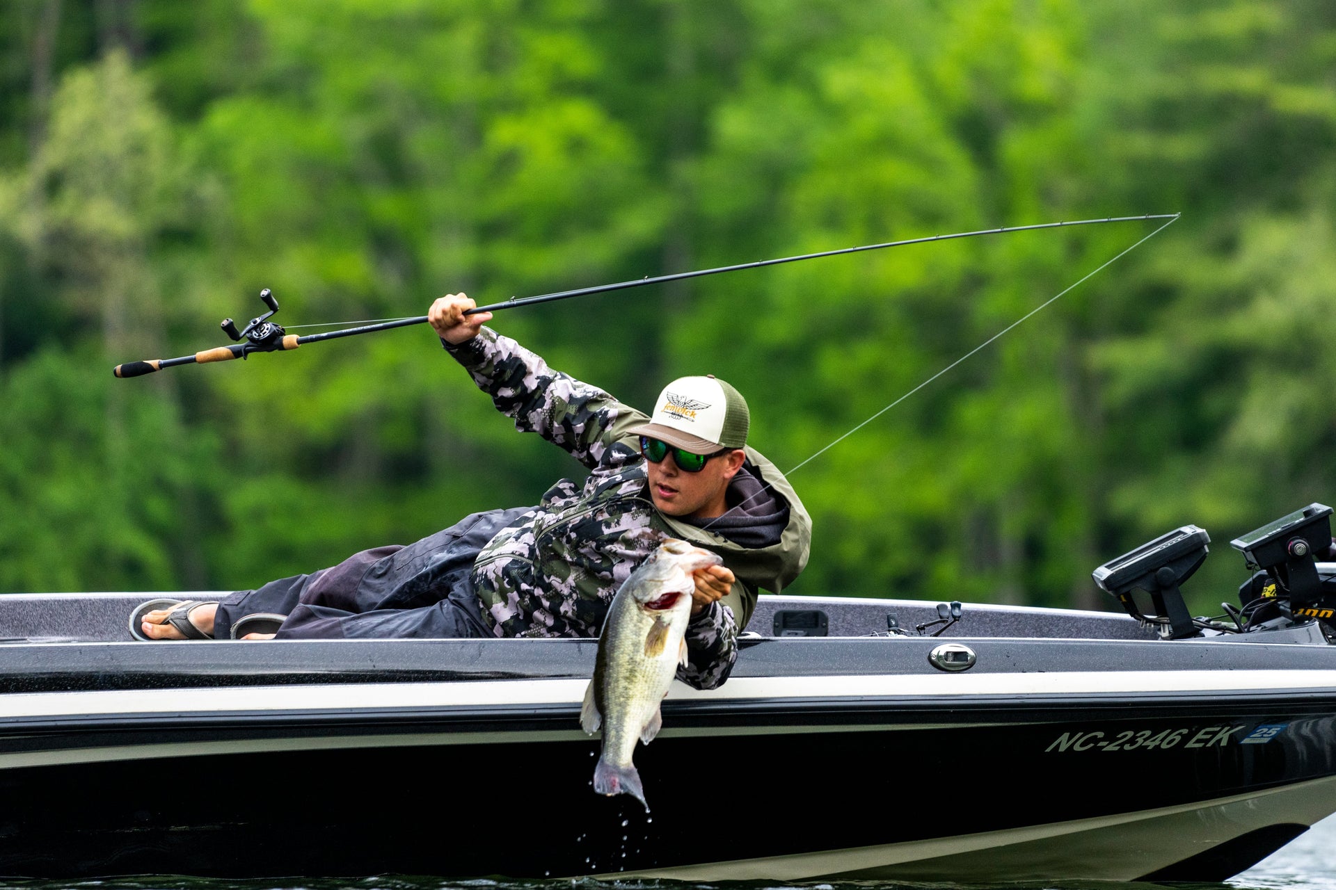 man fishing off a boat with a fenwick rod