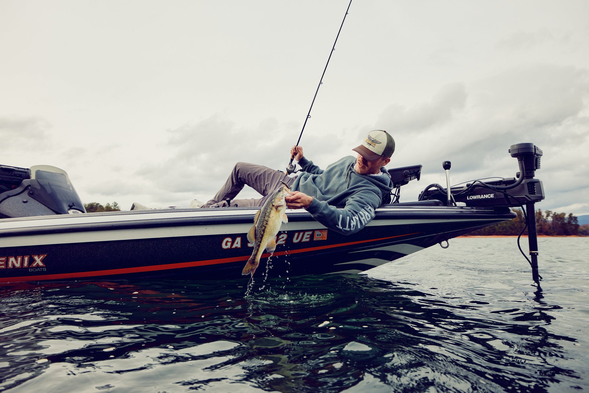 man catching a fish on a boat using a Fenwick rod