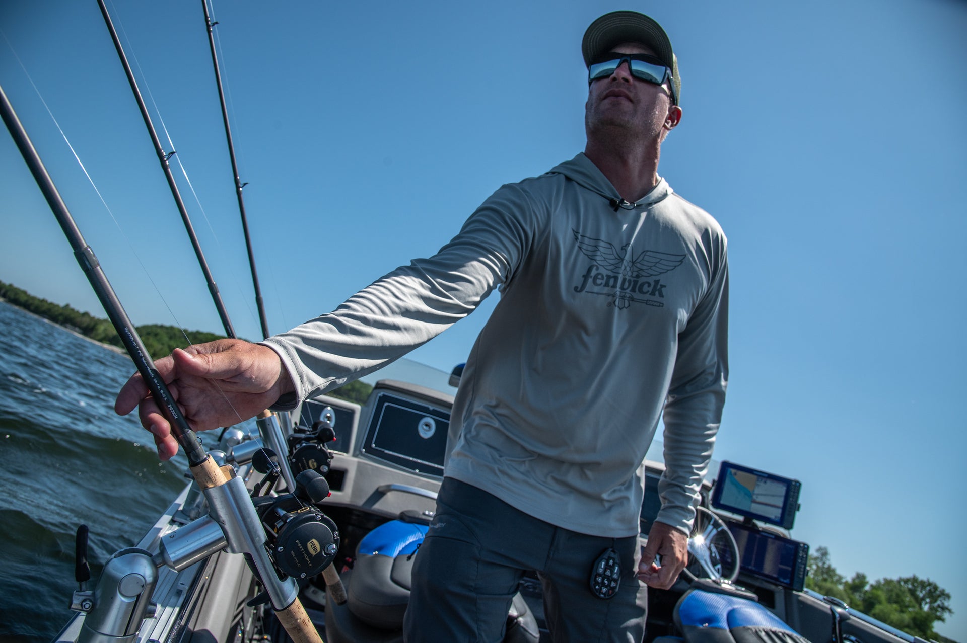 Man wearing Fenwick shirt on a boat