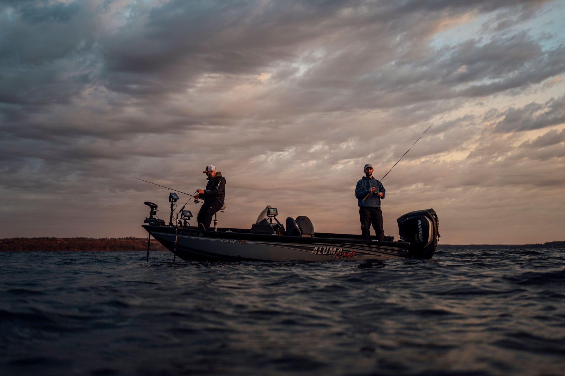 Men fishing on a boat on a cloudy day
