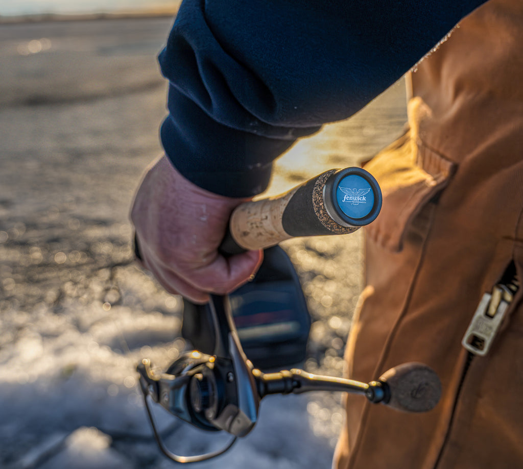 Person holding a Fenwick fishing combo on a frozen lake