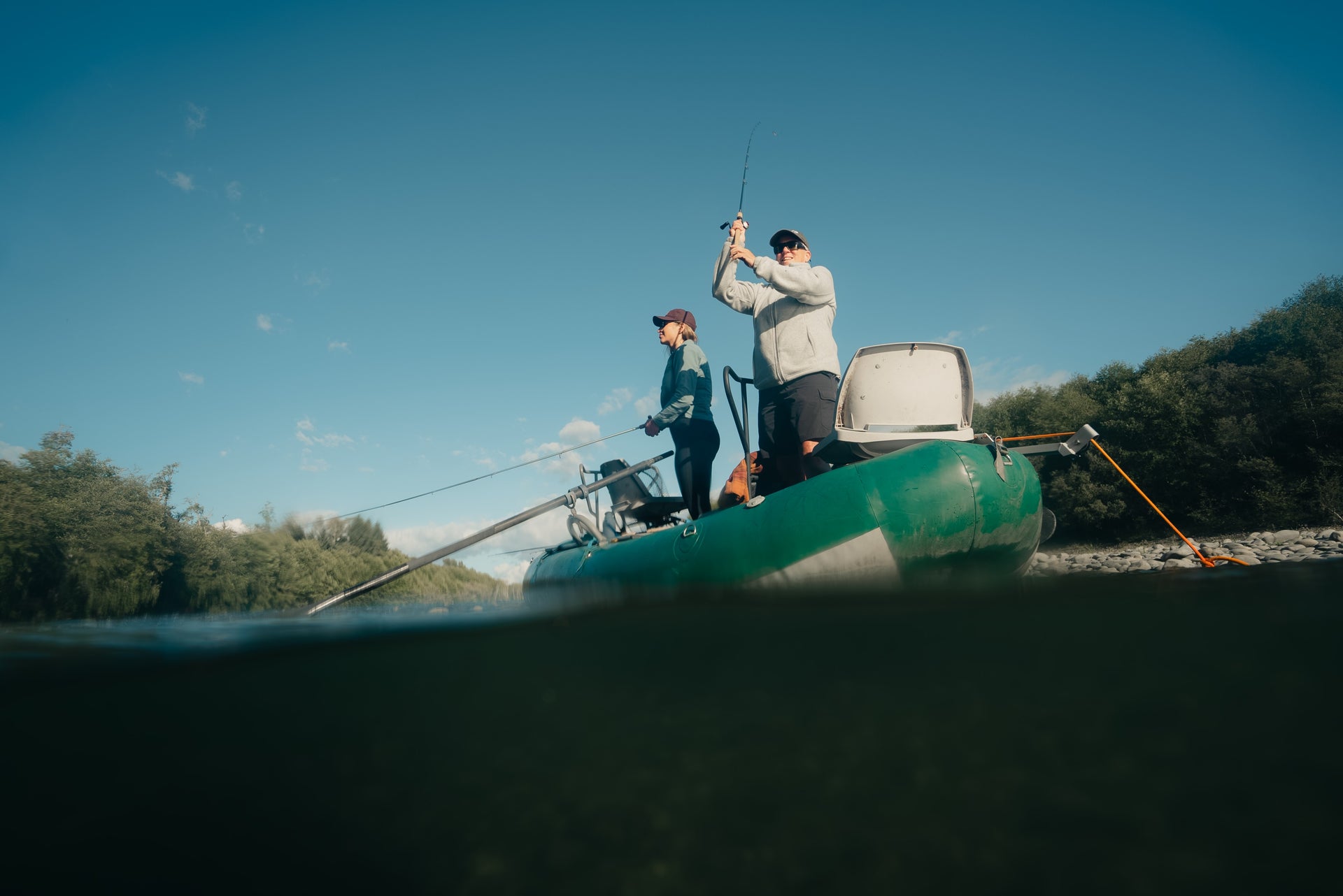2 people fishing off a boat
