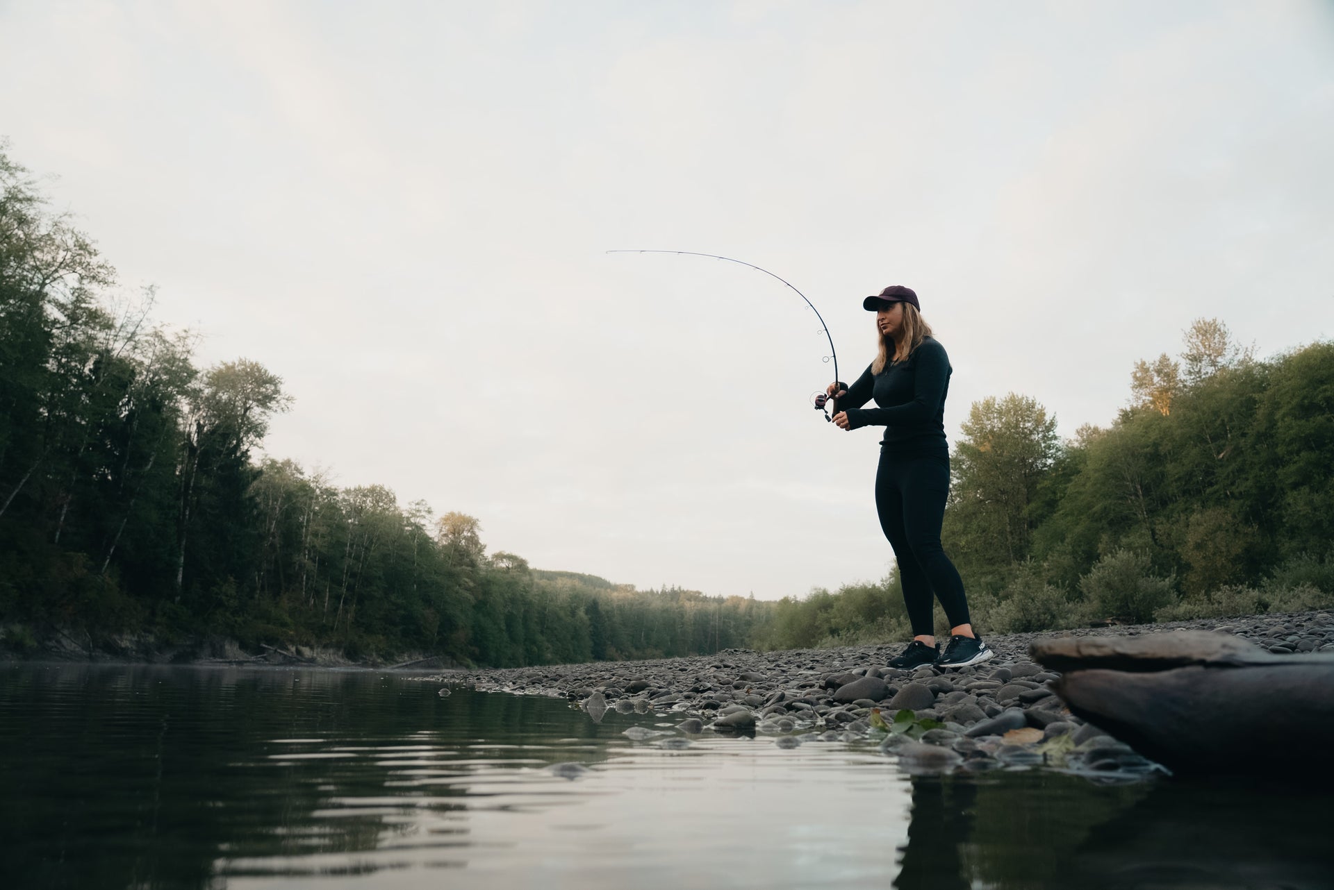 Woman fishing on the shore