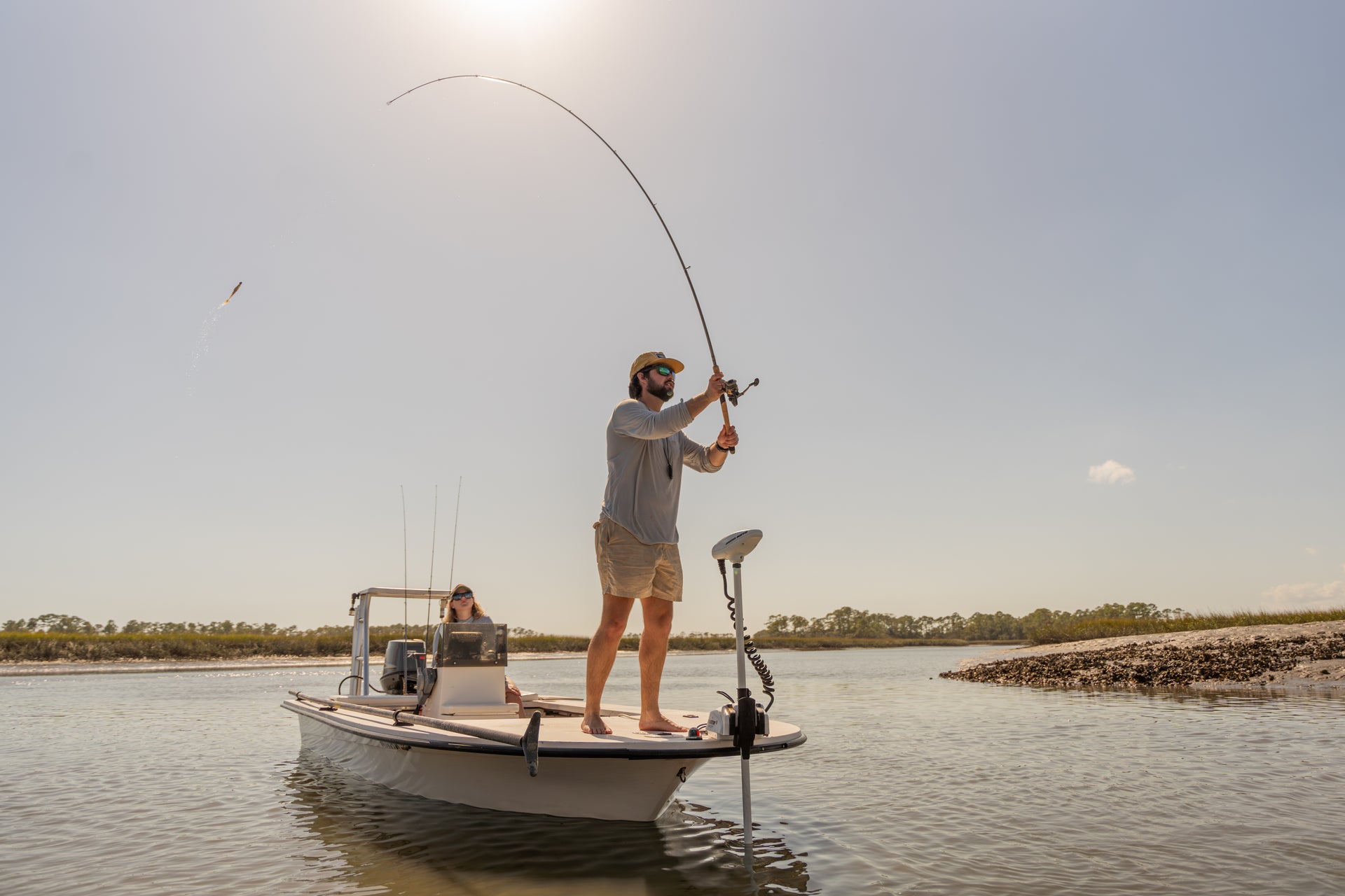 Man fishing on the edge of a boat
