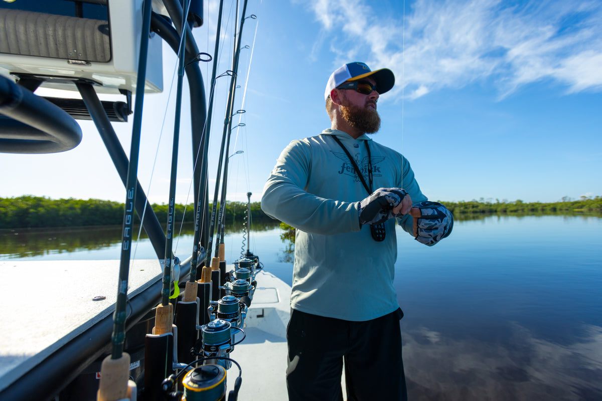 Man on a boat with eagle inshore fishing rods